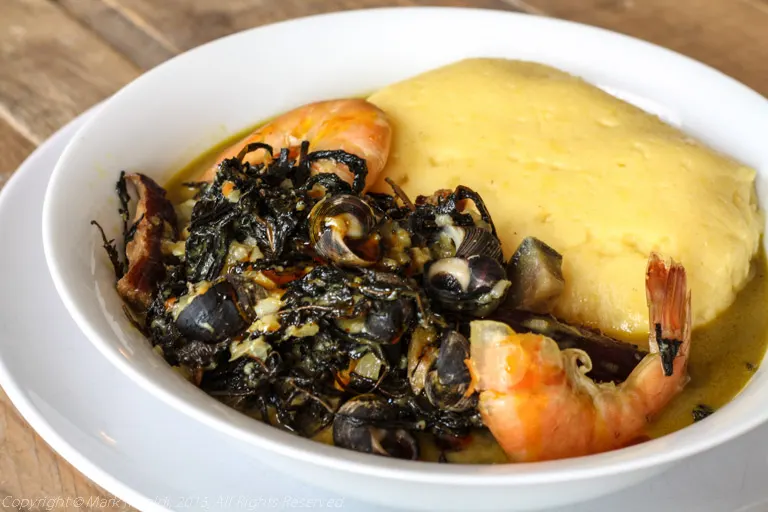 Ndolé with shrimp, drizzled with palm oil
